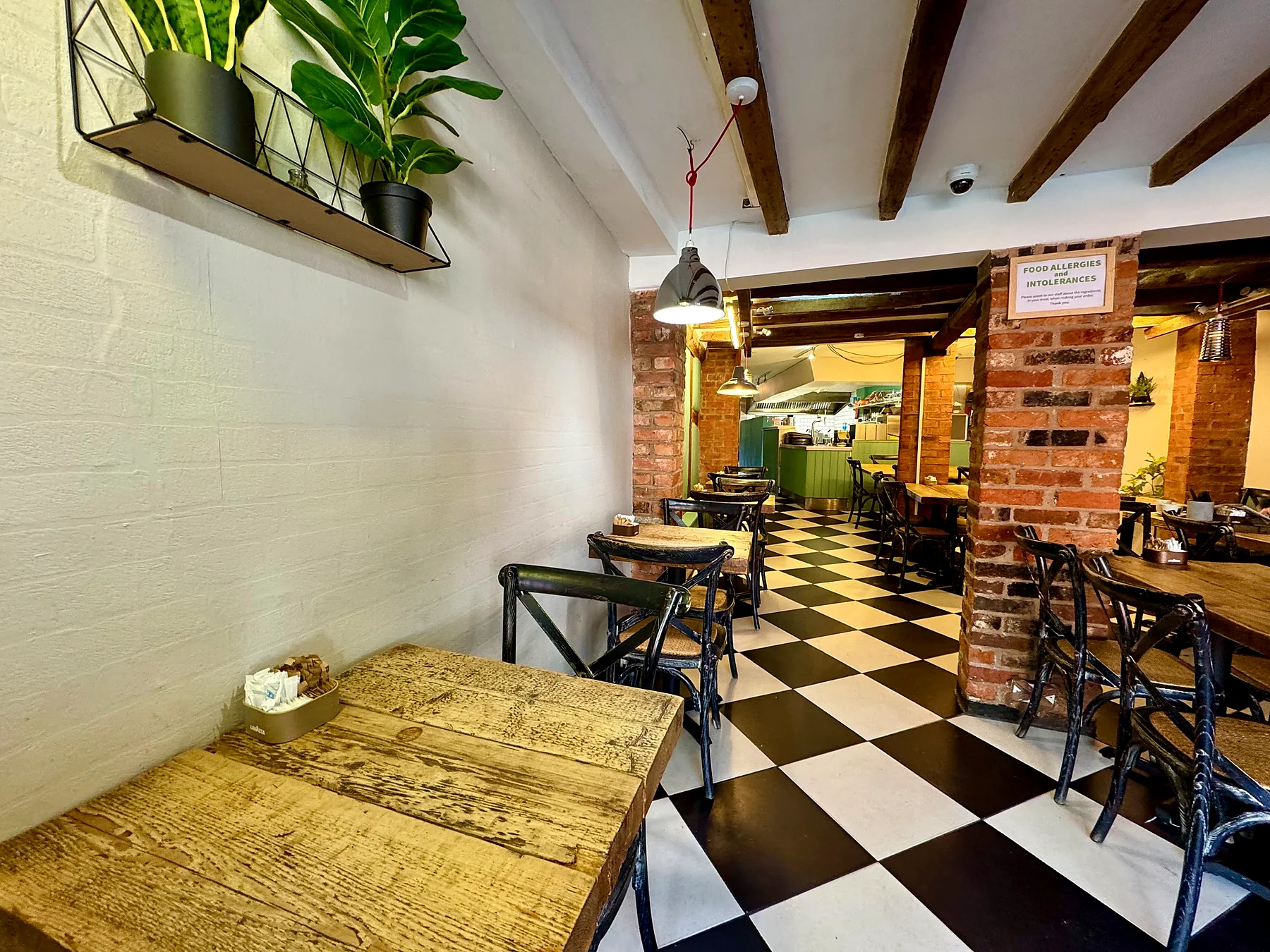 Bensons interior with brickwork and a checkerboard floor